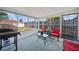 Enclosed sunroom with tile flooring and an outdoor grill at 12901 College Hill Dr, Hudson, FL 34667