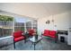 Sunroom with red chairs, ceiling, and tile flooring at 12901 College Hill Dr, Hudson, FL 34667