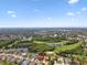 Aerial view of a home nestled in a community with lakes, golf course and lush greenery at 13028 Prestwick Dr, Riverview, FL 33579