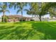 Expansive backyard showcasing lush lawn, mature trees, and outdoor living spaces for entertaining and relaxation at 13028 Prestwick Dr, Riverview, FL 33579