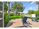 Relaxing backyard patio with chairs and a fire pit overlooking lush green space at 13028 Prestwick Dr, Riverview, FL 33579