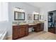 Bathroom with dual wood vanities, vessel sinks, granite countertops, and walk-in closet at 13028 Prestwick Dr, Riverview, FL 33579