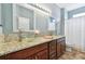 Updated bathroom with dual sinks, granite counters, and modern fixtures at 13028 Prestwick Dr, Riverview, FL 33579