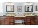 Bathroom with dual wood vanities, vessel sinks, and granite countertops at 13028 Prestwick Dr, Riverview, FL 33579
