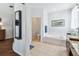Well-lit bathroom featuring tile flooring, a soaking tub, a glass vessel sink, and ample storage at 13028 Prestwick Dr, Riverview, FL 33579