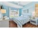 Bright bedroom featuring wood floors, ceiling fan, and a large window at 13028 Prestwick Dr, Riverview, FL 33579