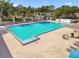 Large, well-maintained community pool with lounge chairs and a brick-paved sun deck at 13028 Prestwick Dr, Riverview, FL 33579