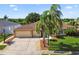 Charming home exterior with lush landscaping, a well-manicured lawn, and a spacious three-car garage at 13028 Prestwick Dr, Riverview, FL 33579