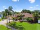 Inviting home exterior showcasing lush landscaping, a well-maintained lawn, and a spacious driveway at 13028 Prestwick Dr, Riverview, FL 33579
