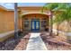 Inviting front entrance with blue double doors, decorative windows, and lush tropical landscaping at 13028 Prestwick Dr, Riverview, FL 33579