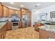 Well-equipped kitchen features stainless steel appliances, granite countertops, and wooden cabinetry at 13028 Prestwick Dr, Riverview, FL 33579