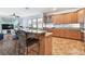 Open kitchen featuring granite countertops, stainless appliances, and a breakfast bar area at 13028 Prestwick Dr, Riverview, FL 33579