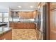 Bright kitchen showcasing stainless steel appliances, granite counters, and ample wooden cabinet space at 13028 Prestwick Dr, Riverview, FL 33579