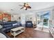 Spacious living room featuring modern furnishings, wood floors, and sliding door access to the pool at 13028 Prestwick Dr, Riverview, FL 33579