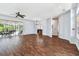 Spacious living room featuring wood floors, ceiling fan, sliding glass doors, and access to the outdoor patio at 13028 Prestwick Dr, Riverview, FL 33579