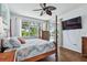 Inviting main bedroom with backyard views, four-poster bed, ceiling fan, and ample natural light at 13028 Prestwick Dr, Riverview, FL 33579