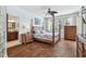 Comfortable main bedroom with a four-poster bed, ceiling fan, and an ensuite bathroom at 13028 Prestwick Dr, Riverview, FL 33579
