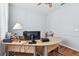 Well lit home office with a neutral color palette, functional desk, and minimalist decor at 13028 Prestwick Dr, Riverview, FL 33579