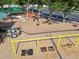 Aerial view of a playground, featuring swings, climbing structures, and picnic areas at 13028 Prestwick Dr, Riverview, FL 33579