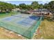 Overhead view of the fenced community tennis courts surrounded by mature trees and landscaping at 13028 Prestwick Dr, Riverview, FL 33579