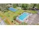 Aerial view of the community pool and tennis courts at Pine Ridge at Sugar Creek in Lecanto, Florida at 13205 Cypress Hill Dr, Hudson, FL 34669