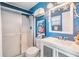 Bathroom showcasing cool toned walls and a walk in shower with glass doors and modern vanity at 13205 Cypress Hill Dr, Hudson, FL 34669