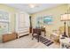 Bedroom offers a cozy space with a large window for natural light, complimented by light yellow walls at 13205 Cypress Hill Dr, Hudson, FL 34669