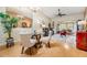 Bright dining area featuring a glass table, four chairs, and views of a sunroom through sliding glass doors at 13205 Cypress Hill Dr, Hudson, FL 34669