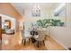 Cozy dining area with a glass table, four chairs, and a large potted plant for added ambiance at 13205 Cypress Hill Dr, Hudson, FL 34669