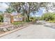 View of the Pine Ridge at Sugar Creek entrance with a road leading into the deed restricted community at 13205 Cypress Hill Dr, Hudson, FL 34669