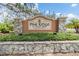 Pine Ridge at Sugar Creek entrance sign surrounded by well maintained landscaping and stone accents at 13205 Cypress Hill Dr, Hudson, FL 34669