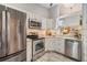 Modern kitchen featuring stainless steel appliances and sleek white cabinetry at 13205 Cypress Hill Dr, Hudson, FL 34669