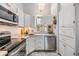 Bright kitchen featuring white cabinets and stainless steel appliances at 13205 Cypress Hill Dr, Hudson, FL 34669