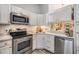 Well-lit kitchen with stainless steel appliances and elegant countertops at 13205 Cypress Hill Dr, Hudson, FL 34669