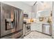 Modern kitchen featuring stainless steel appliances and sleek white cabinetry at 13205 Cypress Hill Dr, Hudson, FL 34669
