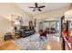 Inviting living room with a comfortable sofa, decorative rug, and a glimpse into the bright sunroom at 13205 Cypress Hill Dr, Hudson, FL 34669