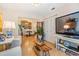 Bright living room with hardwood floors, featuring a view into the dining area and comfortable seating at 13205 Cypress Hill Dr, Hudson, FL 34669