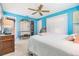 Bright main bedroom featuring cool toned walls, light floors and a ceiling fan with a wooden finish at 13205 Cypress Hill Dr, Hudson, FL 34669