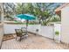 Private patio with a white fence, an umbrella, and a cozy seating area at 13205 Cypress Hill Dr, Hudson, FL 34669