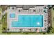 Overhead view of community pool, spa, and sundeck with tables and lounge chairs at 13205 Cypress Hill Dr, Hudson, FL 34669