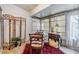 Sun room showcasing tiled floors and large windows with a decorative screen and comfortable seating at 13205 Cypress Hill Dr, Hudson, FL 34669