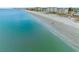 Aerial view of beach front hotels and people walking along the beach at 13500 Gulf Blvd # 706, Madeira Beach, FL 33708