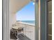 Relaxing balcony with seating and panoramic ocean views at 13500 Gulf Blvd # 706, Madeira Beach, FL 33708