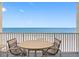 Beautiful beach view from balcony with table and chairs at 13500 Gulf Blvd # 706, Madeira Beach, FL 33708