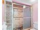 The primary bathroom features a tiled shower with glass block and a sliding door at 13500 Gulf Blvd # 706, Madeira Beach, FL 33708