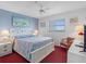 Bright bedroom featuring a queen bed, white furniture, and neutral decor at 13500 Gulf Blvd # 706, Madeira Beach, FL 33708