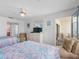 Bedroom with balcony access, two beds, and a cozy sitting area at 13500 Gulf Blvd # 706, Madeira Beach, FL 33708