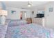 Comfortable bedroom with two beds, dresser, and en-suite bathroom at 13500 Gulf Blvd # 706, Madeira Beach, FL 33708
