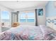 Inviting bedroom with ocean views and access to a private balcony at 13500 Gulf Blvd # 706, Madeira Beach, FL 33708