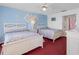Bright bedroom featuring two beds and colorful wall decor at 13500 Gulf Blvd # 706, Madeira Beach, FL 33708